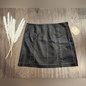 Altar'd State, black with white stitches, faux leather mini skirt.  Size L